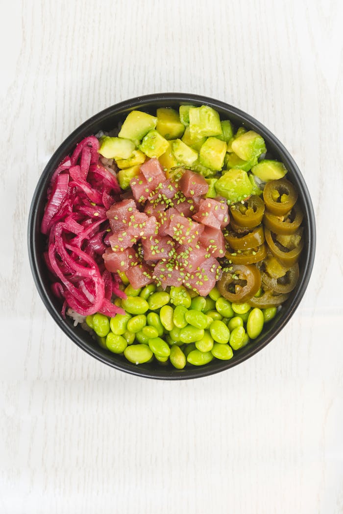 gallery-1 A vibrant poke bowl with fresh tuna, edamame, pickled onions, and more.